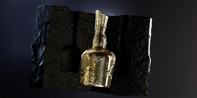 Une bouteille dorée, décorée, repose sur un rocher sombre et inégal sur un fond sombre.