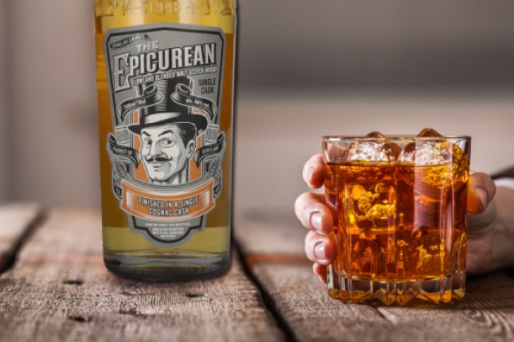 Eine Flasche und Glas Whisky auf rustikalem Holztisch, Hand hält gefülltes Glas mit Eis.