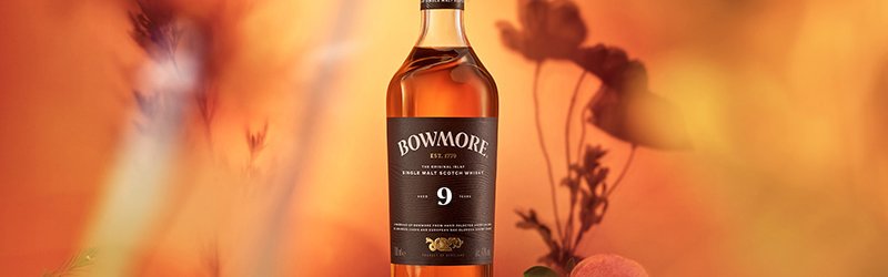 Bowmore whisky on a light background with plants