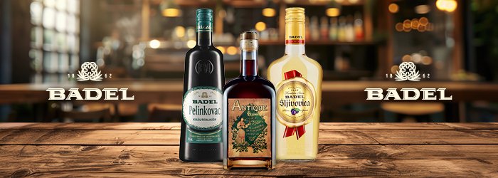 Trois bouteilles de Badel sont posées sur une table en bois ; fond de bar, lumineux et accueillant.